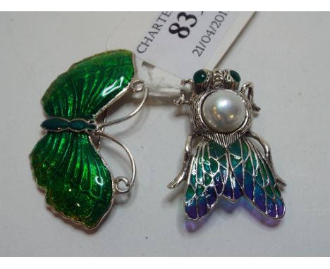 A silver coloured metal and enamel butterfly brooch, and another similar brooch (2) 