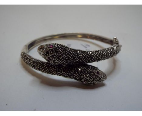 A silver coloured metal snake bangle, set marcasite, and a similar pendant (2) 