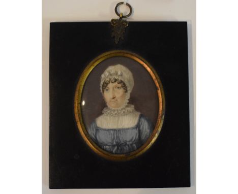 An oval bust portrait miniature, of a lady wearing a mop cap, watercolour, 8 x 6 cm