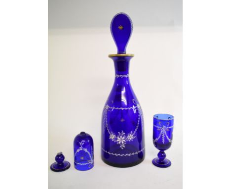 A blue glass decanter and stopper, with enamel and gilt decoration, 34.5 cm high, and a pair of matching glasses, one damaged