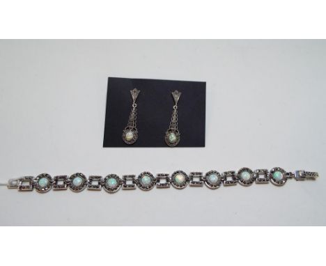 A silver coloured metal, Gilson opal and marcasite bracelet, and a pair of matching drop earrings (2) 