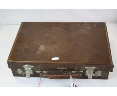 A vintage attache case containing playing cards, brass door knobs, portrait miniature etc.