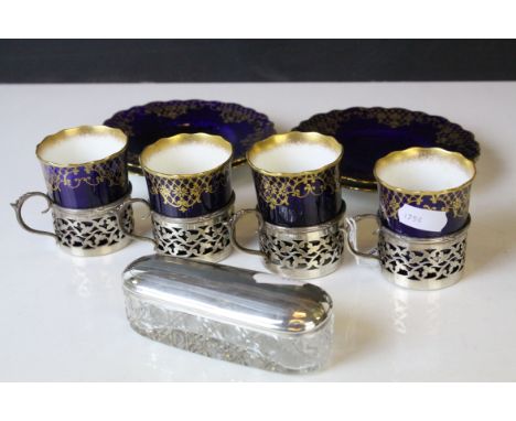 Four Aynsley Cabinet Coffee Cans with Saucers, cobalt blue with gilt highlights, all the cans held within pierced silver hold