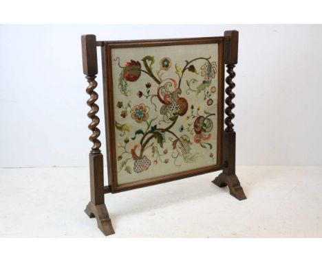 20th century Oak Firescreen with barley-twist supports and a needlework panel, 72cms wide x 78cms high