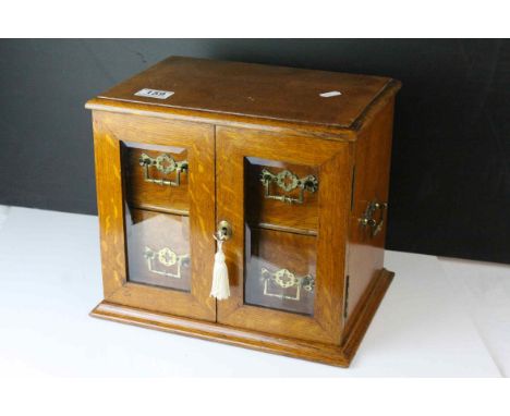 Late 19th century Oak Table Top Cabinet, the two glazed doors opening to reveal drawers with brass handles, 32cms wide x 27cm