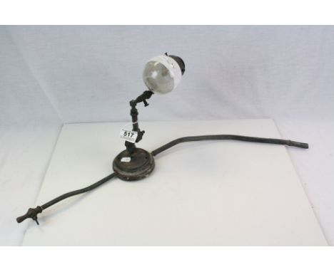 An antique gas light with shade.