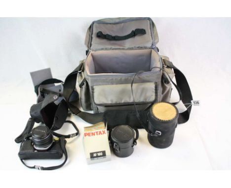 A Pentax Asahi M E camera with bag and accessorie. 