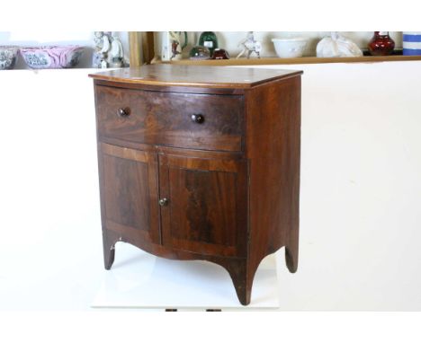 Early 19th century Mahogany Bow-front Washstand with single drawer above a two door pot cupboard, raised on swept bracket fee