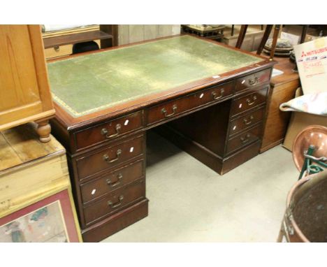 Reproduction George III Mahogany Twin Pedestal Writing Desk, with green leather inset top and an arrangement of nine drawers,