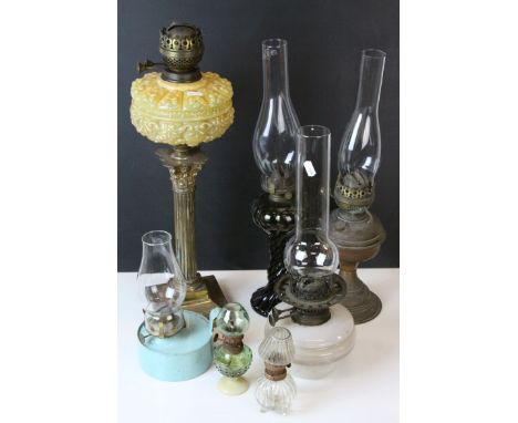 Collection of Oil Lamps including one with a Brass Corinthian Column Support and Moulded Yellow Shade, Two Further Brass, Mou