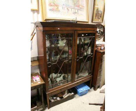 Edwardian Mahogany Display Cabinet, the twin glazed doors opening to reveal two glass shelves, above two drawers and a faux d