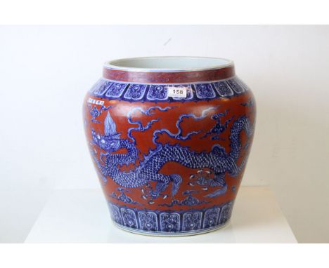 Large Chinese Ceramic Jardiniere decorated with Five Toed Dragons on a Red Ground, 39cms high