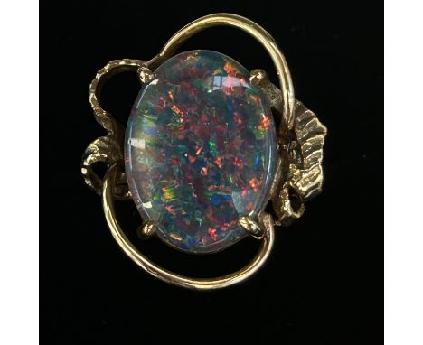 Black opal set in a 9ct gold ring. Stone approx 15.9 mm x 11.9mm Size M.5 Weight 5.2g