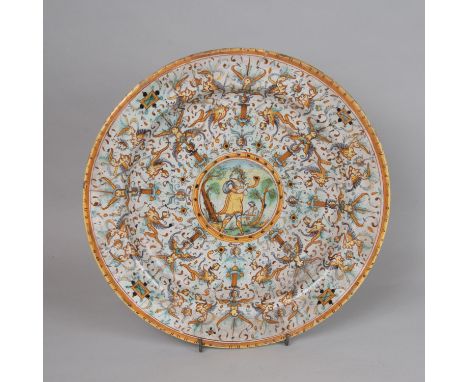 Pesaro Ceramic Dish, round shape deepened center , rich painted decorations in the center flute player, damages, 16/17th Cent