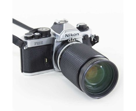 A Nikon FM 2 camera, with a 35-135mm lens, cased