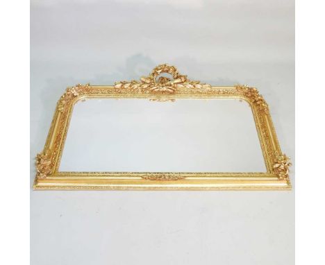 An ornate 19th century style gilt framed over mantel mirror, with a scrolled cresting, 94 x 140cm
