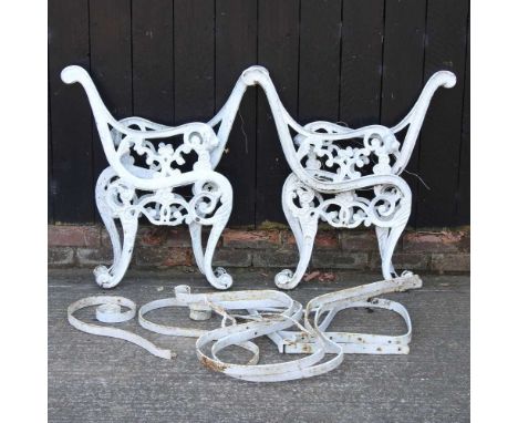 A pair of white painted metal bench ends, together with another pair and bench supports