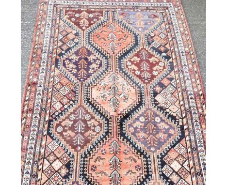 A Persian Lori carpet, with rows of hooked medallions, 278 x 146cm