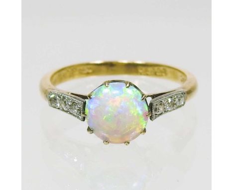 An 18 carat gold opal and diamond ring, with circular opal, approximately 7mm diameter, flanked by diamond shoulders, 2.9g, s