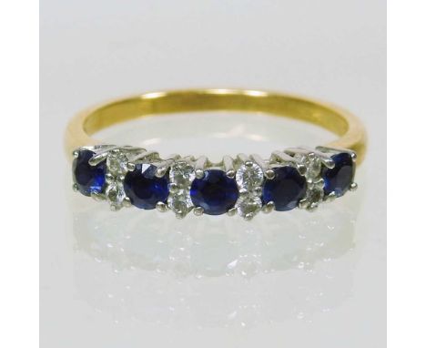 An 18 carat gold sapphire and diamond half hoop eternity ring, set with a row of five sapphires each separated by two diamond