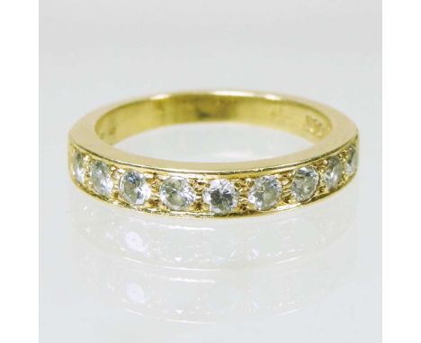 An 18 carat gold and diamond half hoop eternity ring, with a row of nine channel set stones, 3.8g, size M