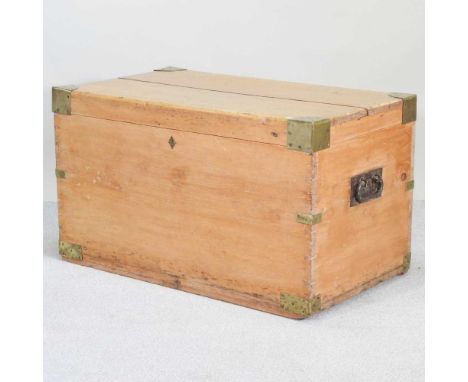 A 19th century brass bound pine trunk, with a hinged lid, flanked by iron carrying handles97w x 58d x 57h cm
