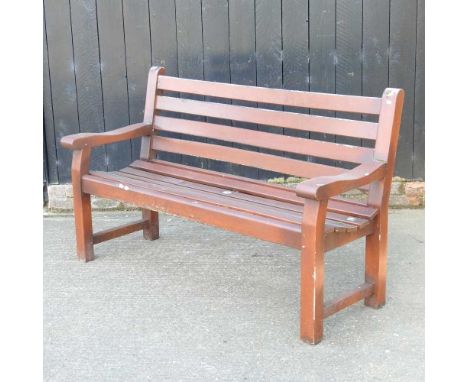A slatted wooden garden bench157cm wide