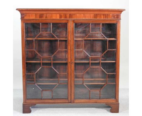An early 20th century mahogany glazed dwarf bookcase, on bracket feet131w x 36d x 132h cm