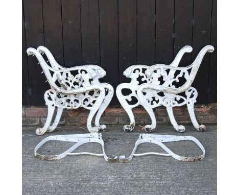 A pair of green painted metal bench ends, 82cm high, together with another pair and bench supports (6)