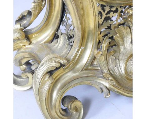 An impressive French ormolu mantel clock, of Rococo style, with an ornate scrolled case, the gilt dial with Roman hours, havi