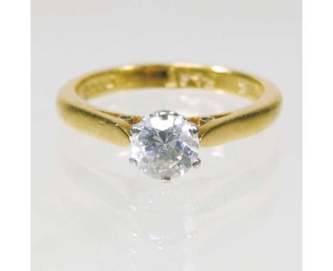 An 18 carat gold and platinum set solitaire diamond ring, approximately 0.65 carats, 4.1g, size L/M