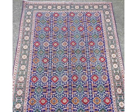 A Persian tabriz carpet, with rows of coloured medallions, 290 x 205cm