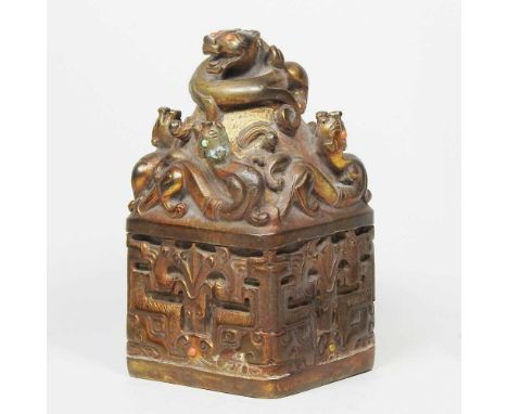 A Chinese gilt metal seal, decorated with a dog of foo, 17cm high
