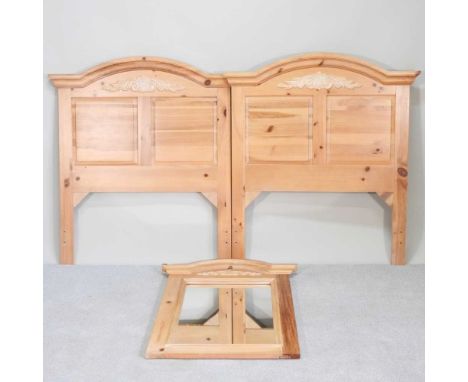 A pair of matching pine headboards, together with a pine American wall mirror (3)