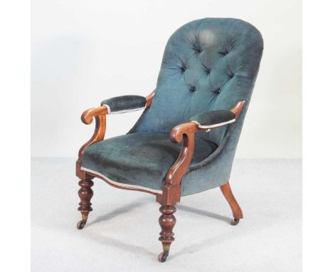 A Victorian blue upholstered button back armchair, on turned legs