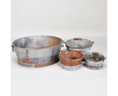 A metal planter, together with three various metal buckets, largest 25cm high (4)