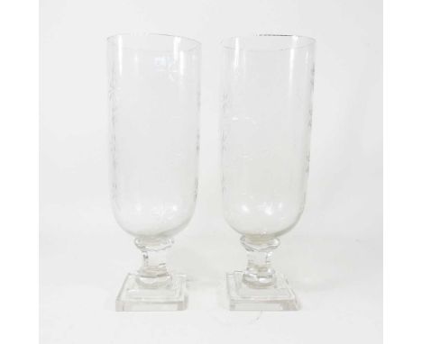A pair of glass storm vases, each having star cut decoration, 34cm high (2)