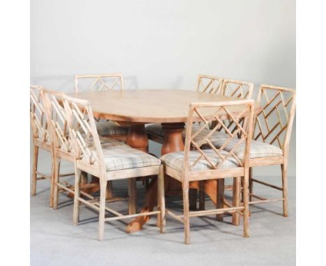 A modern dining twin pedestal pine dining table, together with a set of ten simulated bamboo dining chairs, to include two ca
