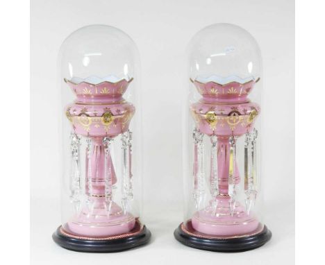 A pair of 19th century pink opaline glass table lustres, each suspended with glass drops and contained under a 19th century g