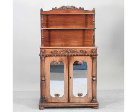 A late Regency carved mahogany chiffonier, of small proportions, with a tiered gallery back, enclosed by mirrored doors below