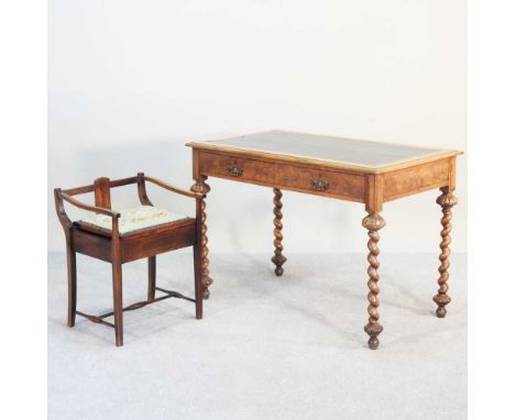 A Victorian walnut writing table, with an inset top, on spirally turned legs, 107cm wide, together with an Edwardian stool (2