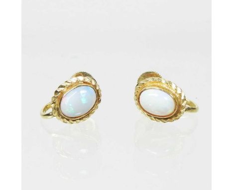 A pair of 15 carat gold, opal earrings, each of oval shape, with a ropetwist surround and screw back, 2.7g, 9mm high (2)