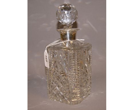 A decanter with a hallmarked silver collar. 