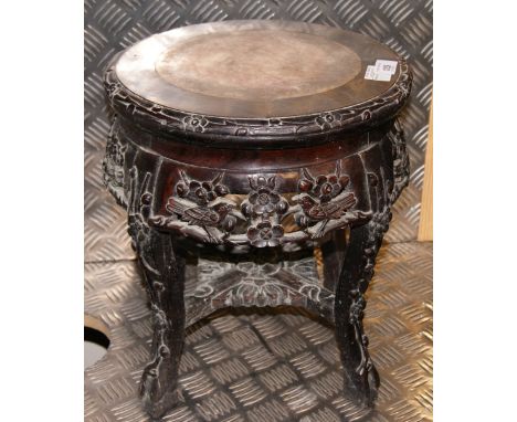 A Chinese pot-stand, in heavily carved hardwood, with a circular marble panel inset to the top CONDITION REPORT; Approximatel