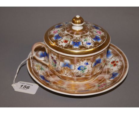 KPM, a gilt and painted ceramic chocolate cup, with saucer and cover