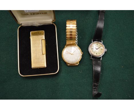 Two wristwatches and a boxed lighter.