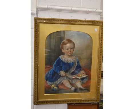 19th century English School, pastel portrait of a young child seated on a cushion holding a book.