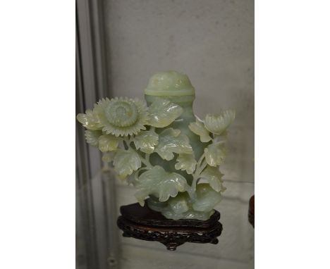 A Chinese carved jade lidded vase on stand.