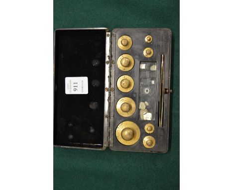 A cased set of gold scales.