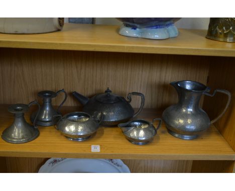 A Tudric pewter four piece tea service, pattern no: 01324, water jug lacking cover, together with a pair of similar chamber s